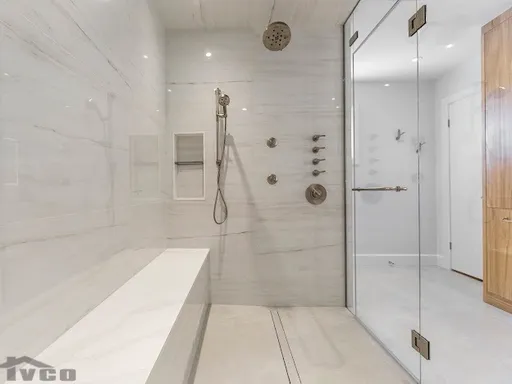 a big shower with a bench inside of it