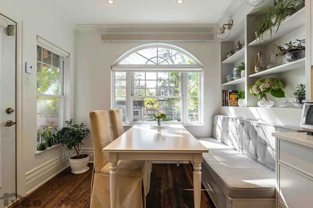 a dining room table with plants and natural light